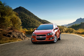 Orange 2013 Chevrolet Sonic LTZ Turbo on winding road