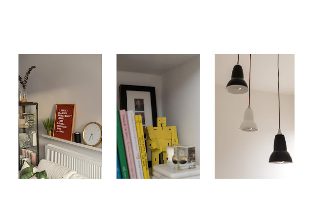 living room details featuring red pen board, travel momentos and anglepoise lamp shades