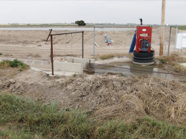 electric pump filling a holding pond