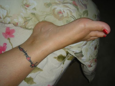 Kerry's Koi & Cherry Blossom Ankle Tattoo. Kerry's tattoo is a simple black