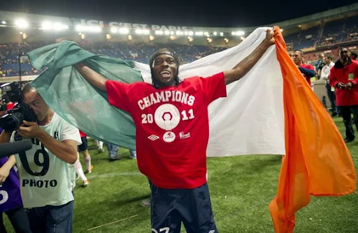 Lille striker Gervinho celebrates with his country's flag after winning the French league title