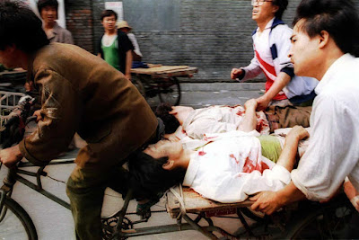 A rickshaw driver fiercely pedals wounded people to a nearby hospital, with the help of bystanders, on June 4, 1989. PLA soldiers again fired hundreds of rounds towards angry crowds gathered outside Tiananmen Square at noon.