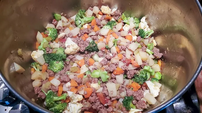 cook veggies and meat in pot