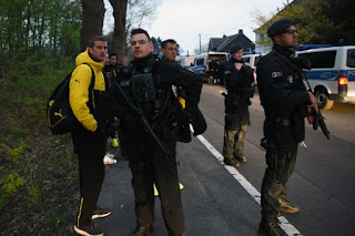 Dortmund players stand with heavily armed police guards