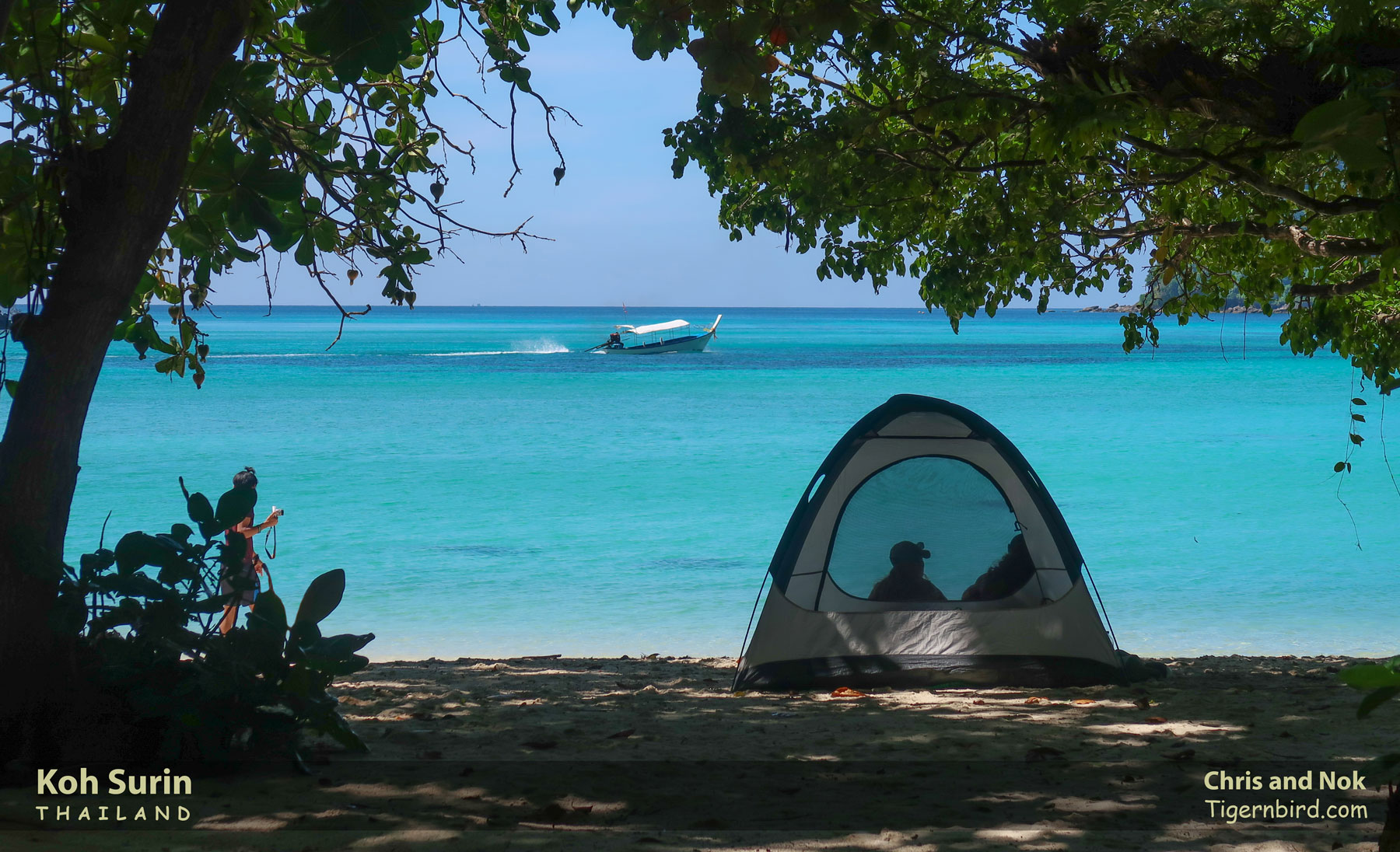 Couple camping before azure waters of andaman sea at mu ko surin national park in thailand