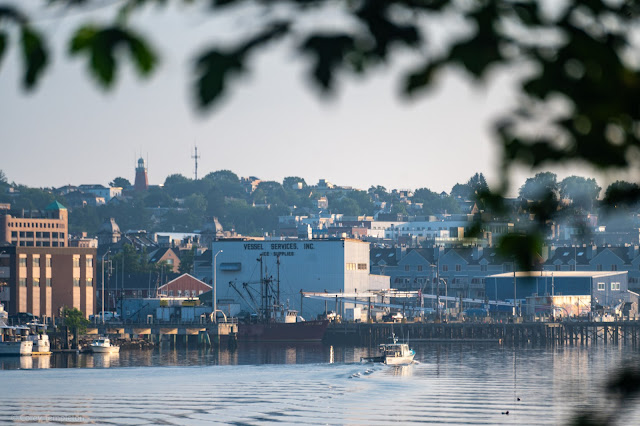 Portland Maine Boating past the wharves and leaving a smooth wake.