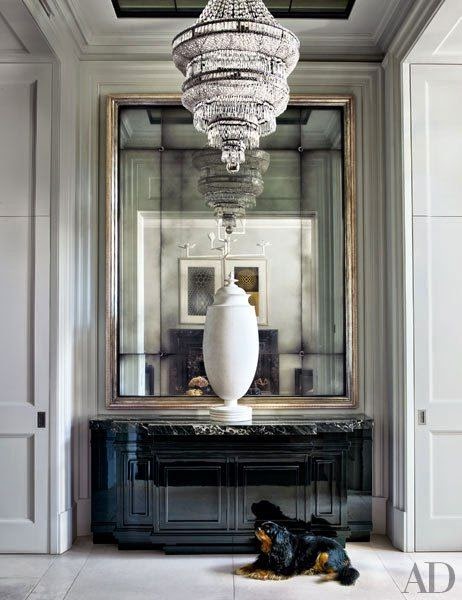 architectural digest foyer vignette crystal chandelier oversized gold gilt mirror
