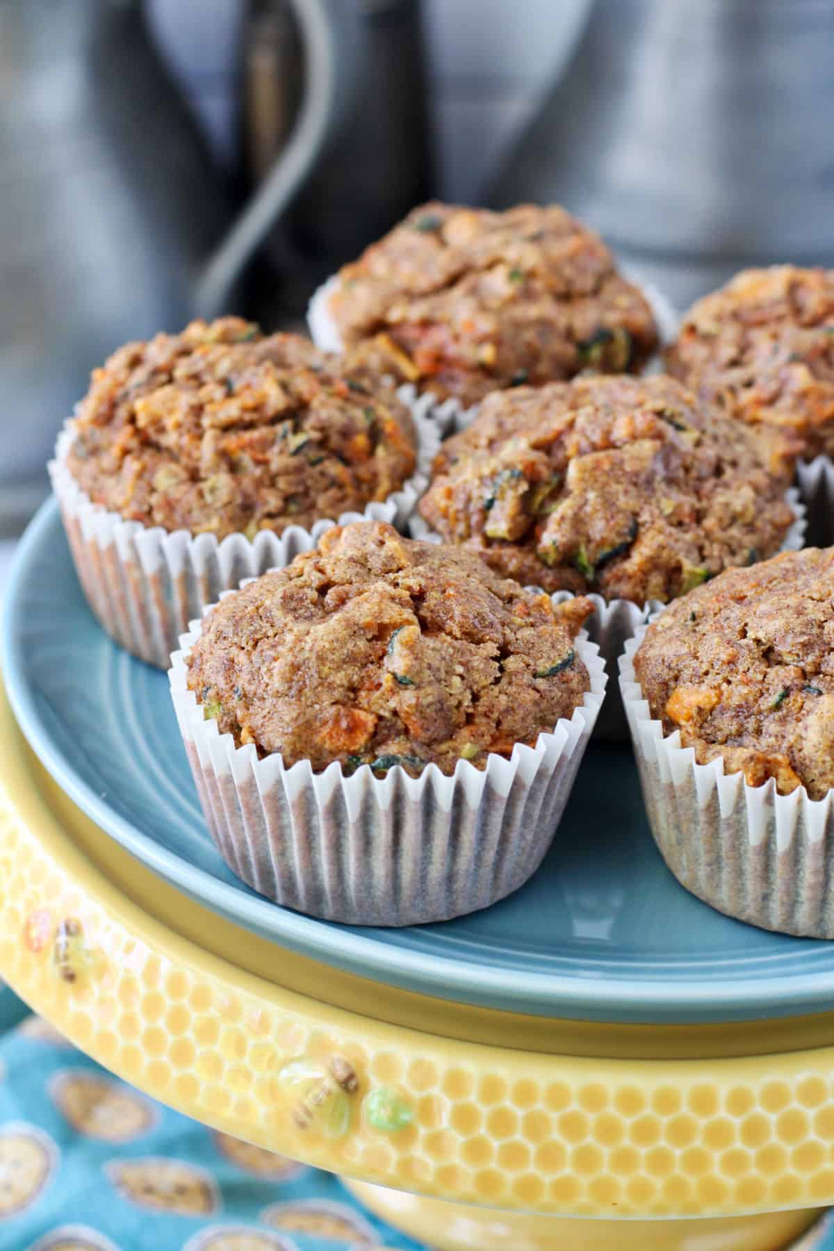 Zucchini Carrot Muffins on a cake stand.