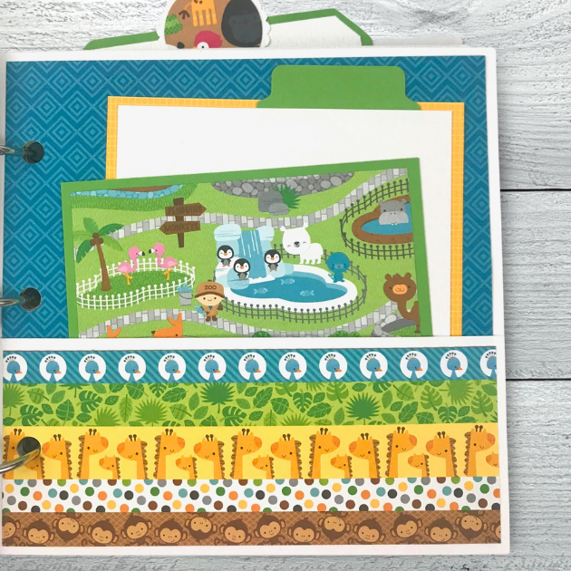 Zoo or Jungle themed scrapbook album page with lots of cute animals, a pocket, and journaling cards