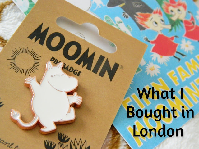 A photo showing a pin badge of a Moomintroll