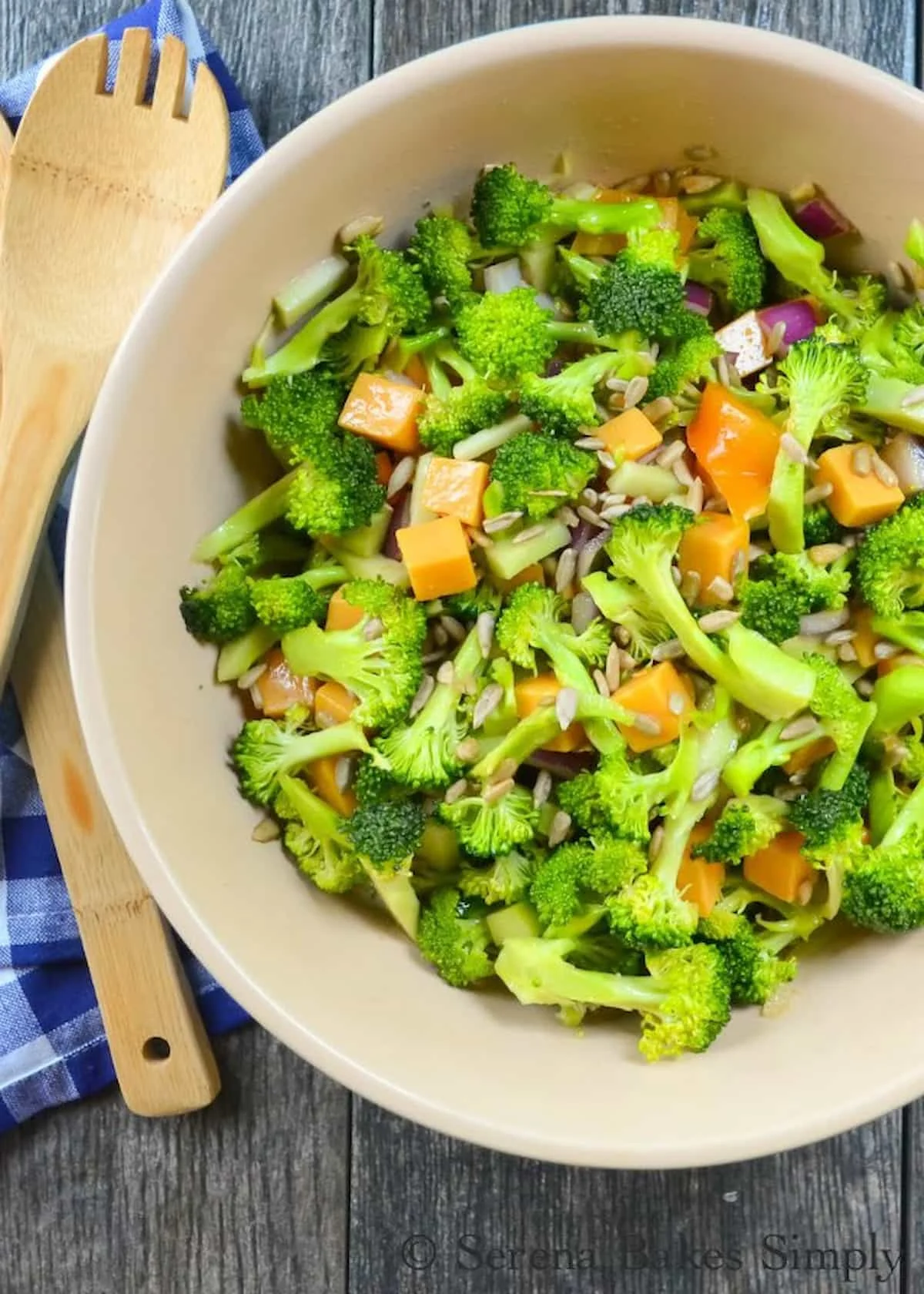 The best crunchy Broccoli Salad recipe in a light sesame seed dressing with cheddar cheese and sunflower seeds is the perfect salad for any gathering including Thanksgiving and Christmas from Serena Bakes Simply From Scratch.