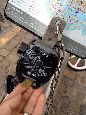 bike rack, 20 kroner coin, and key connect together to secure the bike when not in use