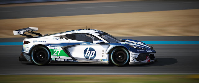 a dark blue and white HP sponsored Corvette C8R photographed from the side