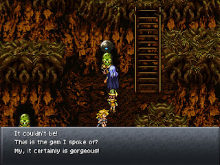 The party shows the Saintstone to a Reptite in the Lost Sanctum, an optional area in Chrono Trigger.