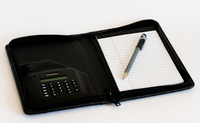 a zippered planner with a calculator and lined notepad