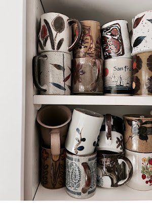 A cupboard of vintage mug