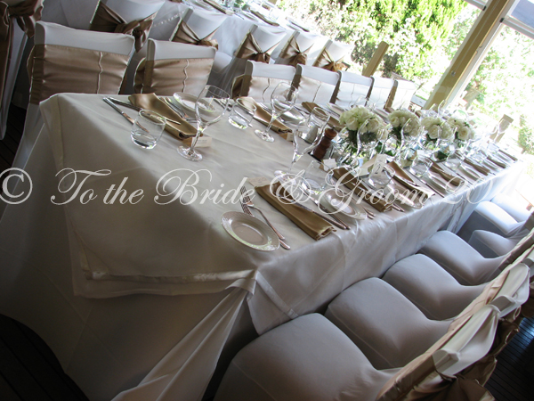 wedding chairs with ivory covers and lace bows