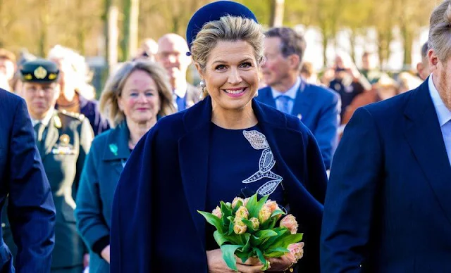 Queen Maxima wore a new stretch wool long sleeve embossed dress by Oscar de la Renta, and navy wool coat by Natan