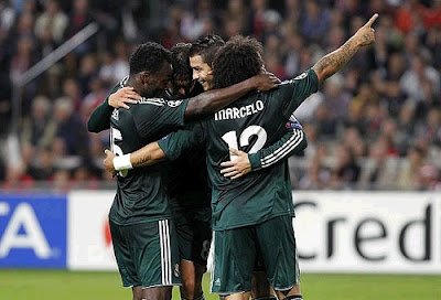 Real Madrid players wearing the green jersey celebrate a goal against Ajax