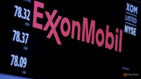 The logo of Exxon Mobil Corporation is shown on a monitor above the floor of the New York Stock Exchange in New York, December 30, 2015. (Credit: Reuters/Lucas Jackson/File Photo) Click to Enlarge.