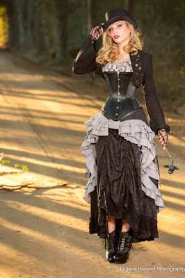 An example of longline corsets used in women's steampunk fashion. this woman is wearing her longline corset with a bustled skirt, top, bolero jacket and hat.