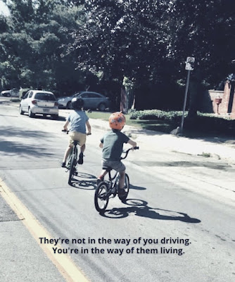 Two boys biking - The're not in the way of you driving, you're not in the way of them living