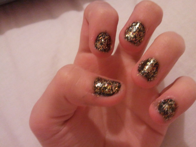 black nail polish with multicoloured glitter on top