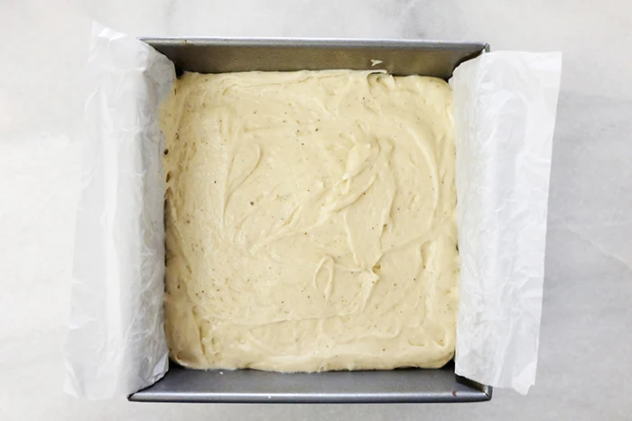 powdered donut cake batter in baking pan