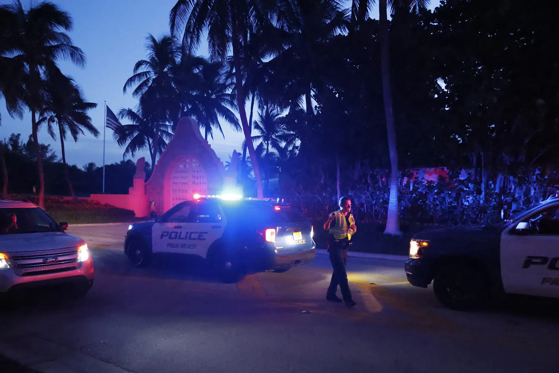 Police direct traffic outside an entry to previous President Donald Trump's Mar-a-Lago bequest in Palm Beach
