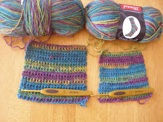 two swatches laying side by side, with the corresponding ball of yarn above each swatch