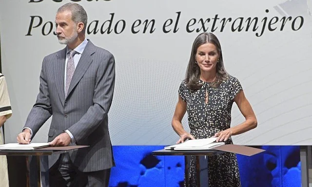 Queen Letizia wore an animal print midi dress by Massimo Dutti. Letizia wore black suede espadrille wedges by Macarena