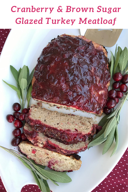 Platter with cranberry and brown sugar glazed turkey meatloaf with slices.
