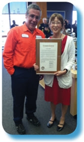 man receiving an award for his heroic act as a County bridge tender