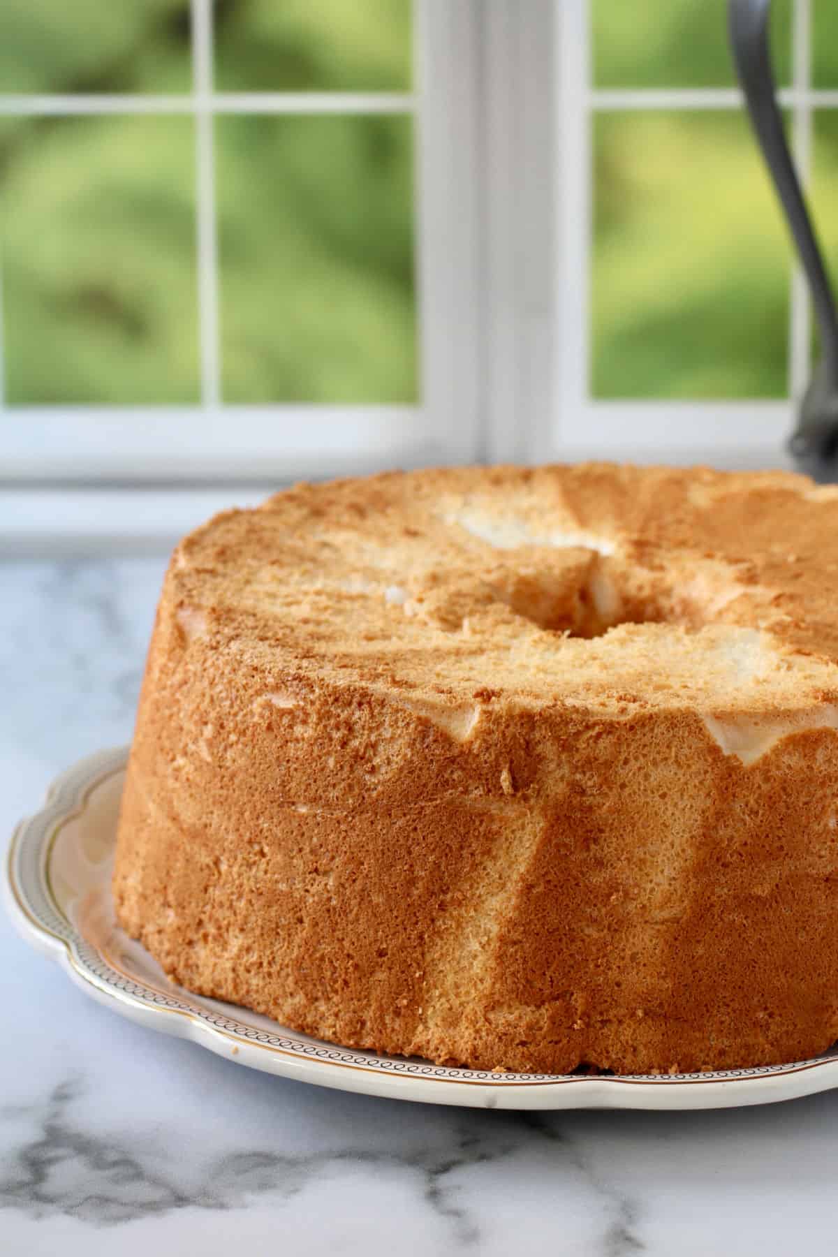 Angel Food Cake with Raspberries, unfrosted on a plate.