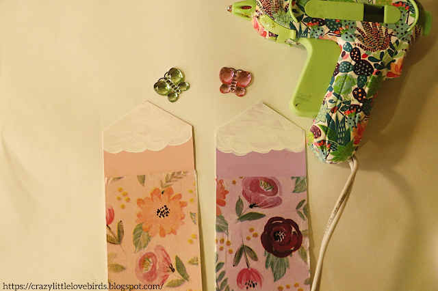 Decorated bookmarks, butterfly gems, and hot glue