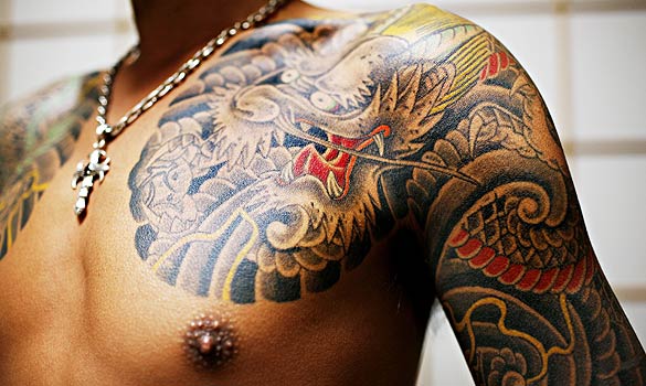 Yakuza is known to tattoo their own members. If you see a black ring around an arm of a Yakuza, this can stand for the number of crimes he committed.