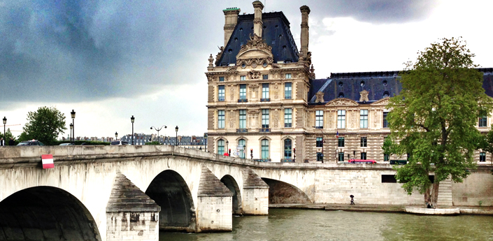 cycling to the Louvre palace along the sein in Paris France 