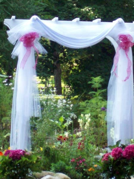 Tulle and draping decorate this garden arbor