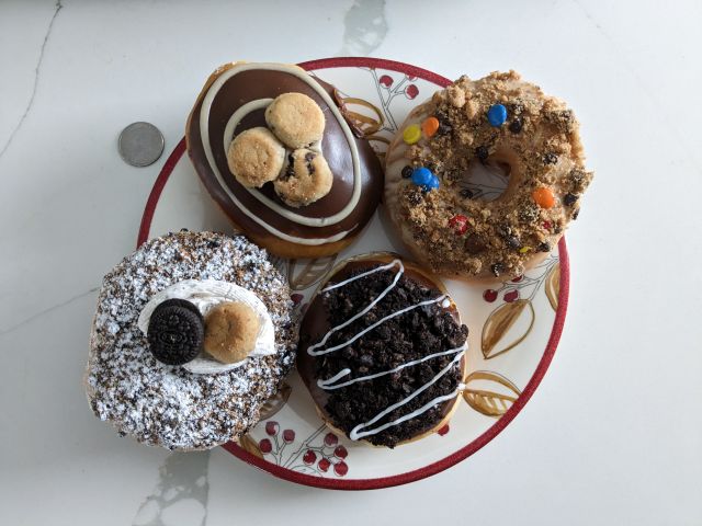 A top-down view of Krispy Kreme's Oreo and Chips Ahoy! Cookie Blast Donuts on a plate
