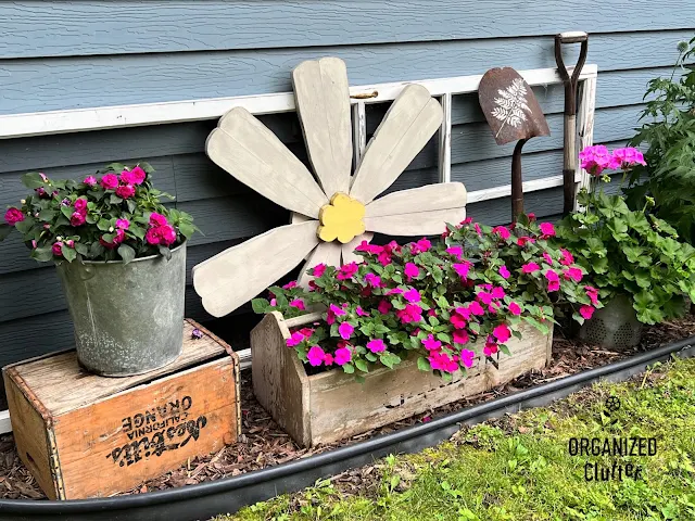 Photo of a junk garden vignette in July.