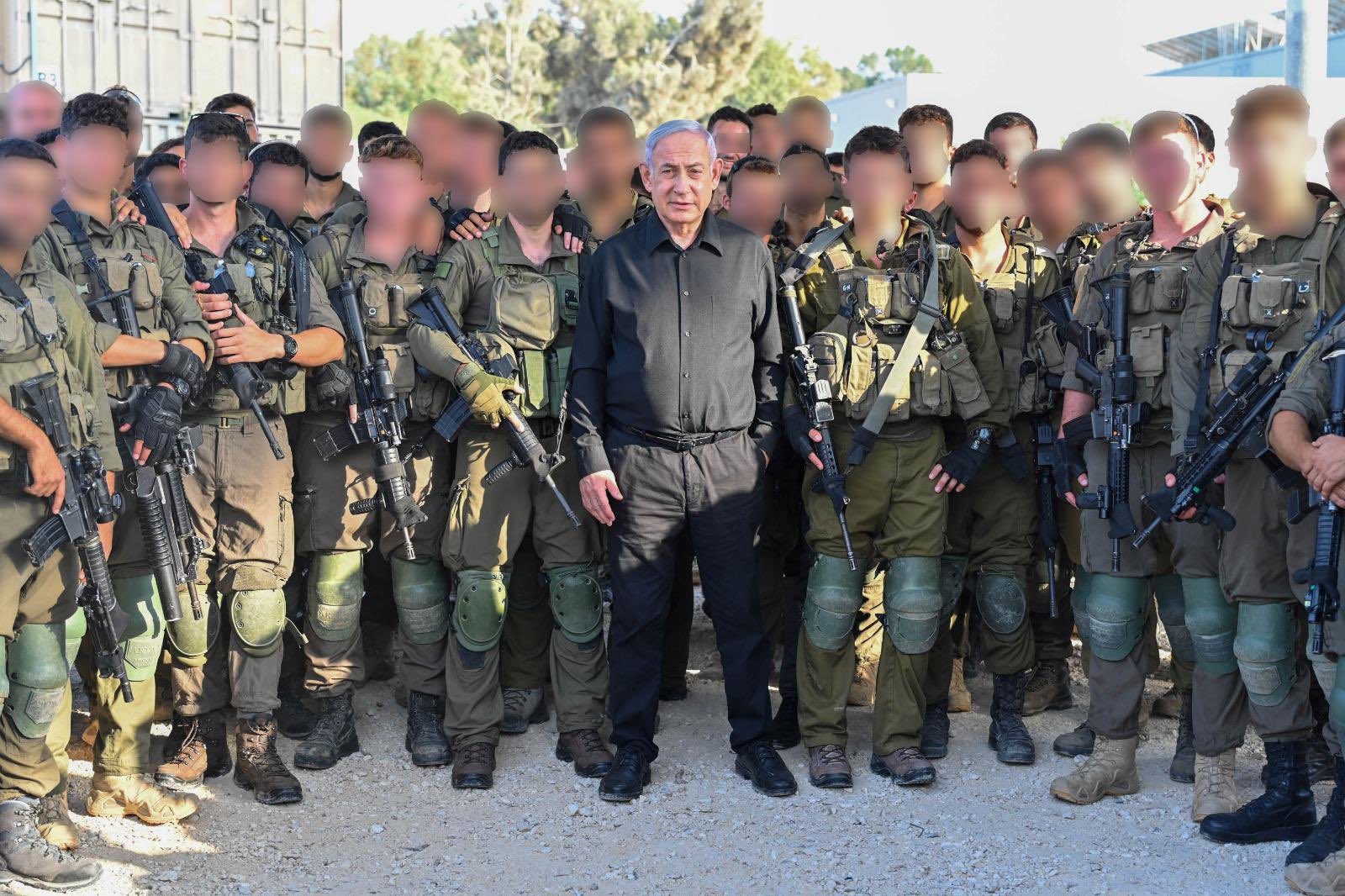Prime Minister of Israel, Benjamin Netanyahu, takes a shot with his Israeli soldiers