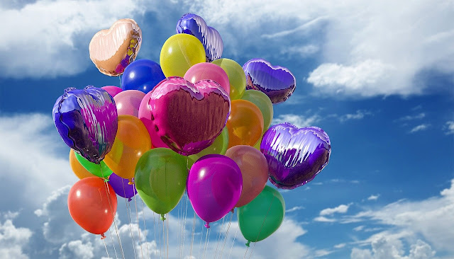 helium-filled balloons in the sky