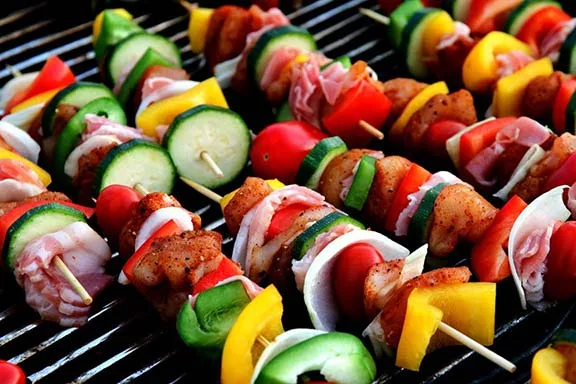 Kebabs cooking on a BBQ.