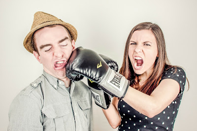 Girl with boxing gloves appears to punch a boy