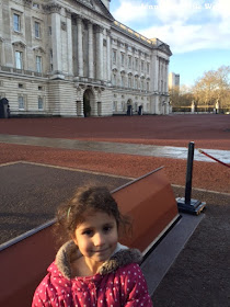 Small child outside Buckingham Palace in London