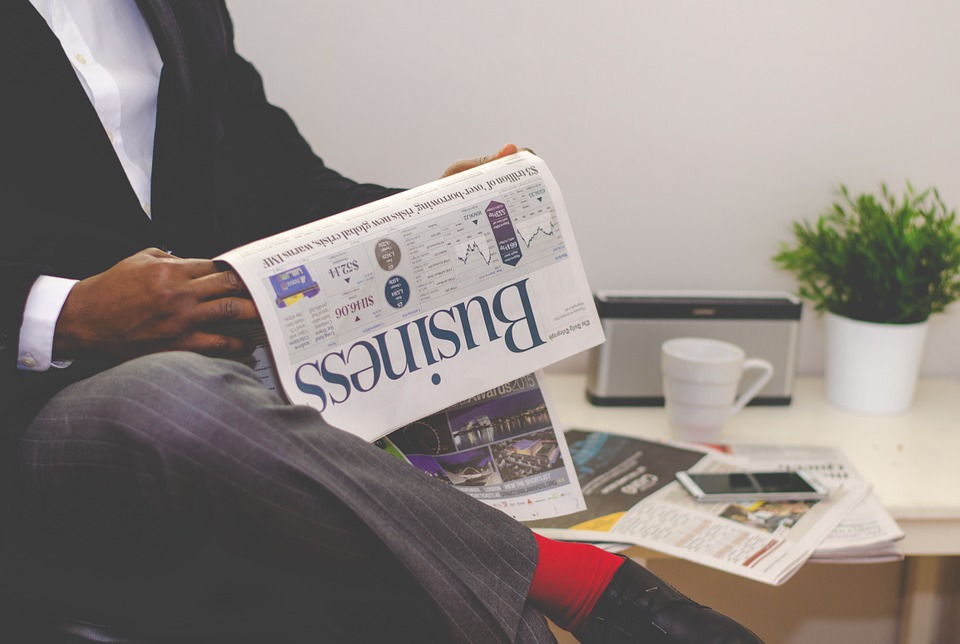 Business man reading newspaper