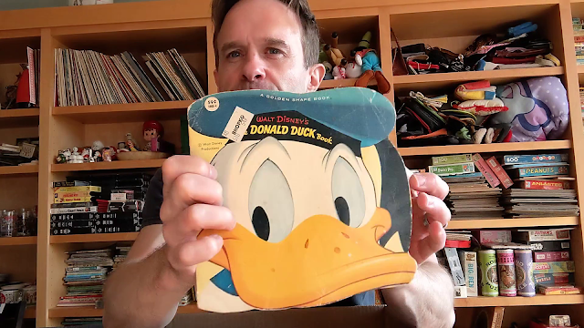 picture of man holding book with duck on it