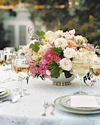 The receptiontable centerpieces star garden roses tucked among fat 