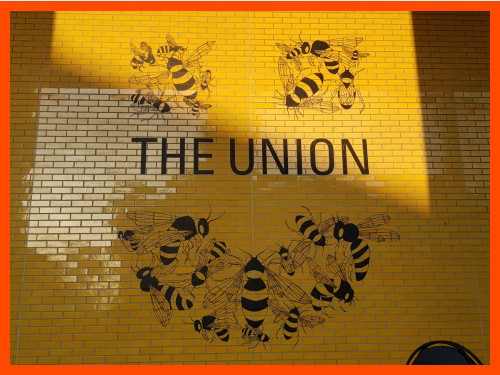 Bee design on a yellow wall