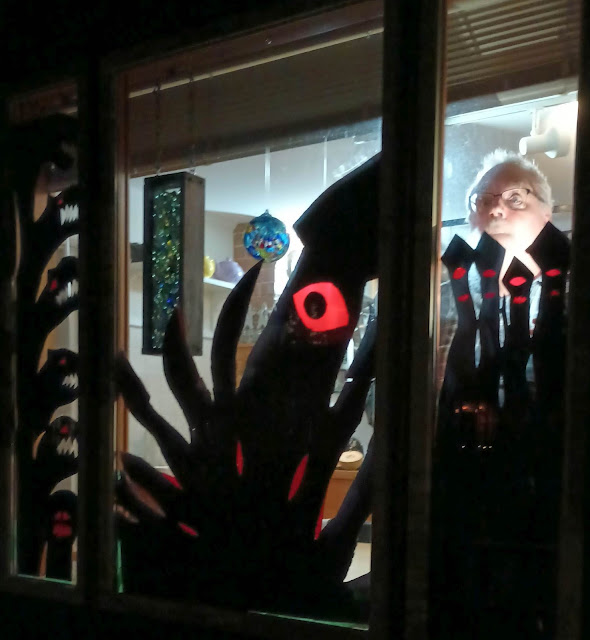 Sea monster silhouettes on the window with a really scary thing behind them